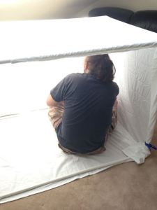 The author is checking that everything is stable, not getting ready to have his picture taken.